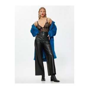 Koton Wide-leg pants with a leather look and mini pockets.