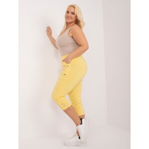 Světle žluté látkové kalhoty velikosti 3/4 plus